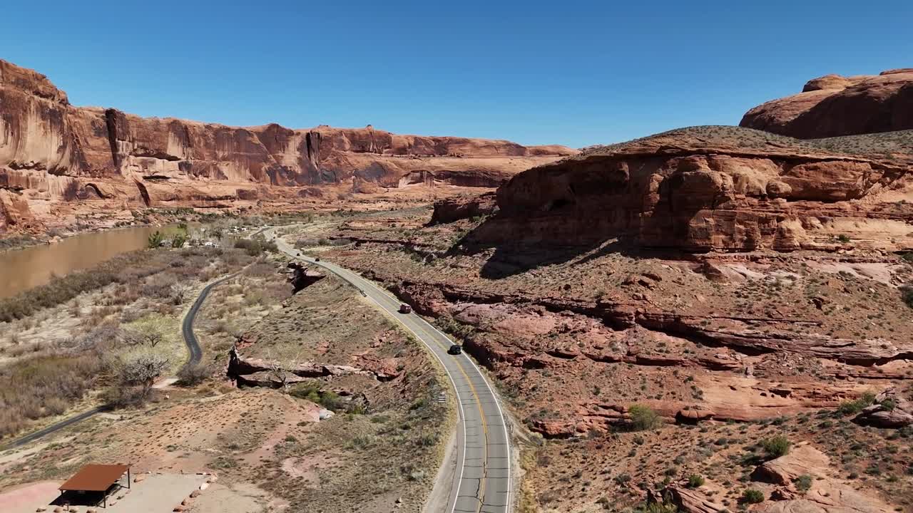 Drone Flying over Highway 128 in Mab Utah, Red Cliffs and Blue Sky