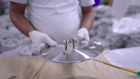 shining and packing steel pans in a cookware factory