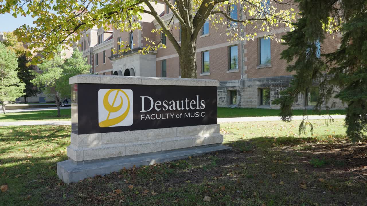 Concrete sign of Desautels Faculty with music logo at Winnipeg campus