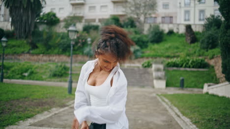 excited african woman dancer enjoy energetic freestyle dance in park close up.