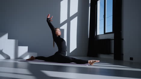 woman doing yoga stretches in a bright studio