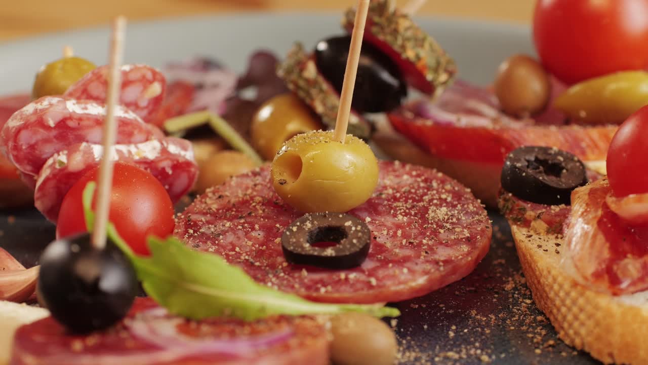 Mix of spanish pork sausages, Cutting board of appetizing catalonian snack - fuet, jamon, chorizo, olives, supermarket tapas food in spain, traditional cuisine.