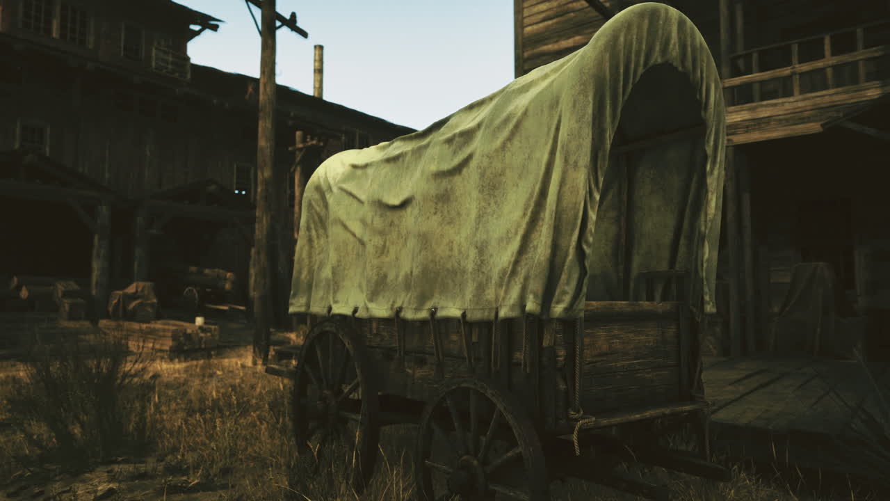 Vintage wagon resting in a rustic western town at sunset