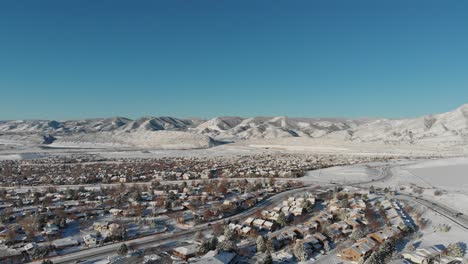 a drone pan over lakewood colorado, red rock in the distance