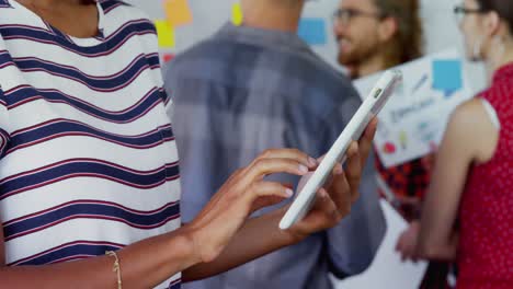 Woman-using-digital-tablet-with-her-colleagues-in-background-4k