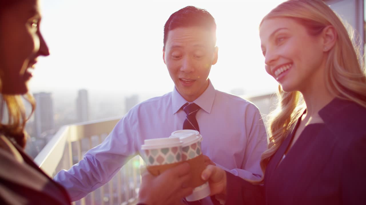 다민족 비즈니스 임원들이 지붕에서 커피를 마시고 있습니다.