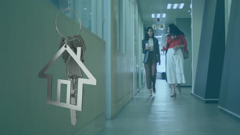 animation of silver house key and key fob over diverse businesspeople