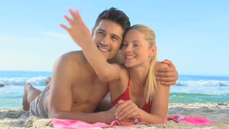 cute couple lying on a beach