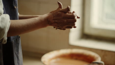 woman preparing clay in studio