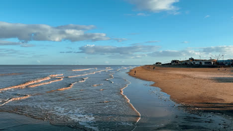 warm coastal sunset scene with people walking through the image