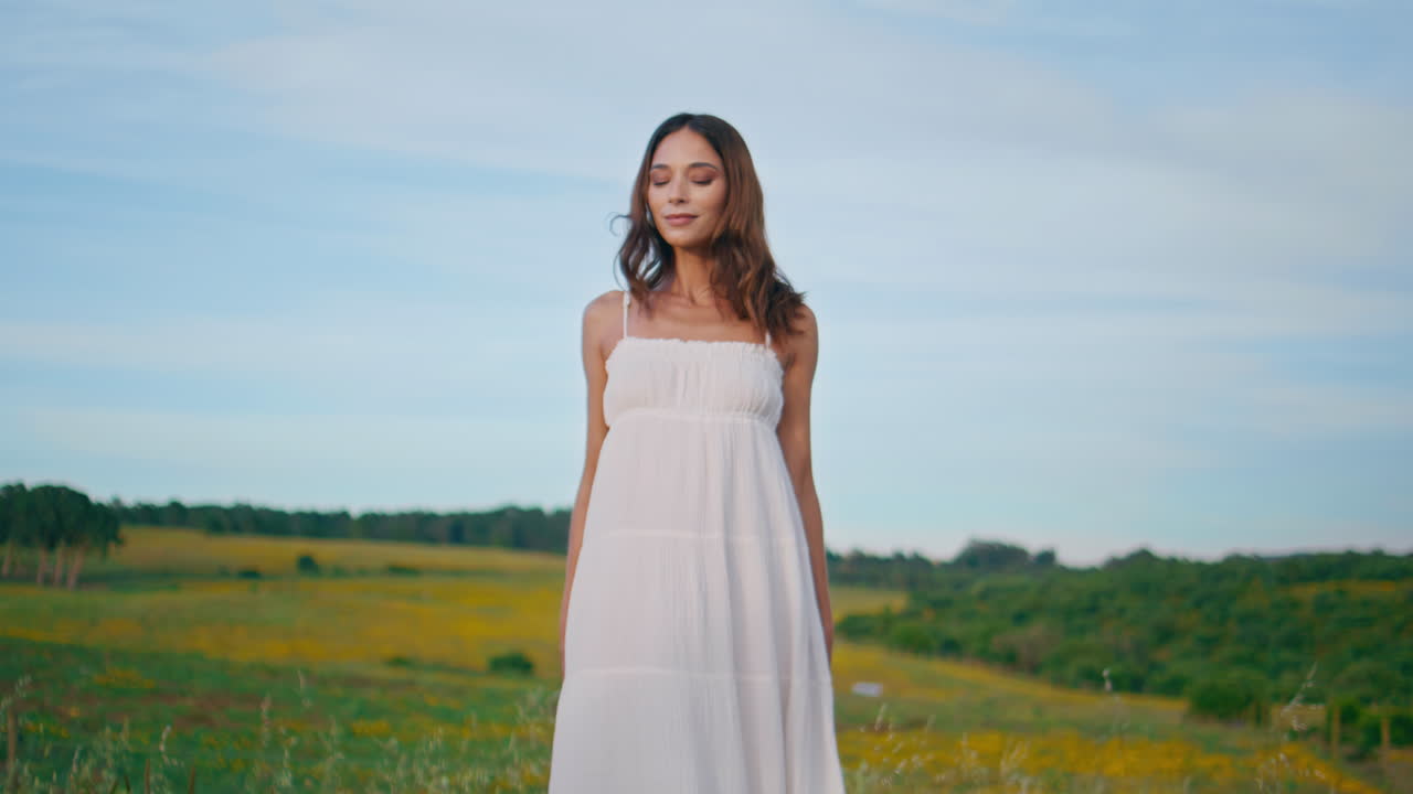 Rural lady attracting hand posing flowers farmland alone. Girl looking camera