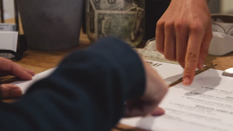 woman serving a customer in a deli explains the menu