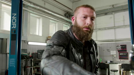 rider parking his motorcycle at the garage