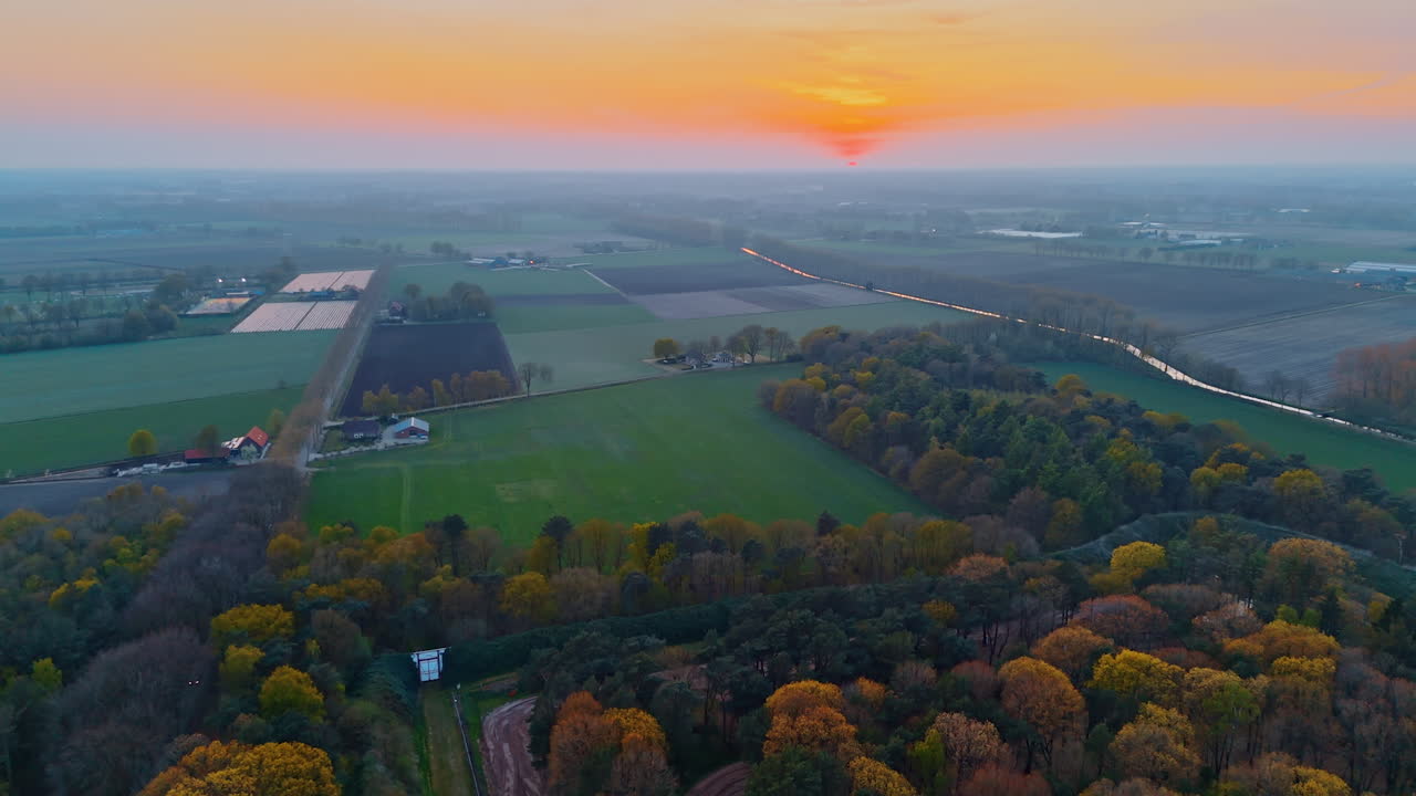 Stunning sunset in Dutch fields. Stunning aerial view of the Netherlands showcasing vibrant fields and a peaceful sunset over the landscape