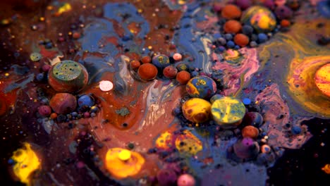 abstract colorful acrylic and food paint bubbles on water