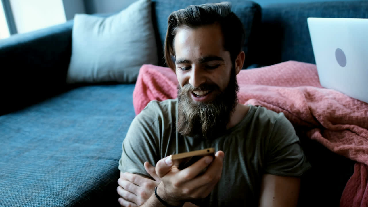 pareja usando teléfono móvil y portátil en la sala de estar 4k