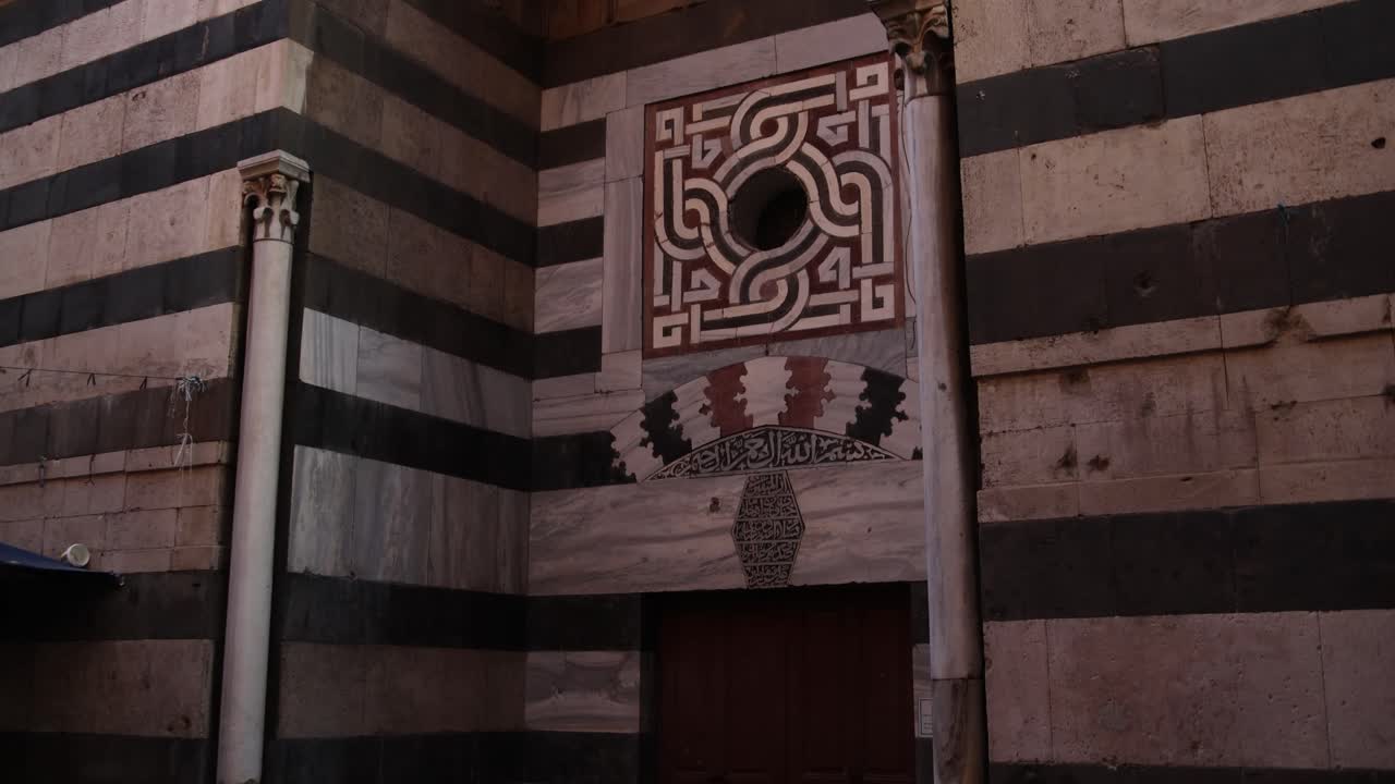 panning shot of black and white archway with intricate islamic designs of old mosque in Tripoli, Northern Lebanon