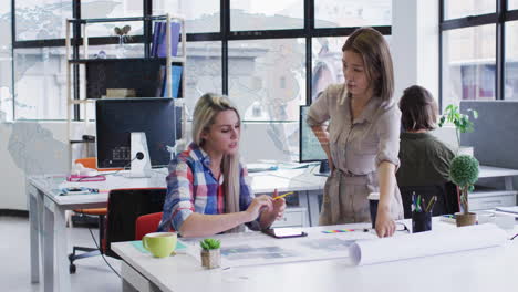 collaborating on design project with animation, two women at modern office