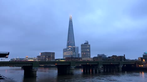 the shard skyscraper and river thames in city of london on a gloomy stormy day