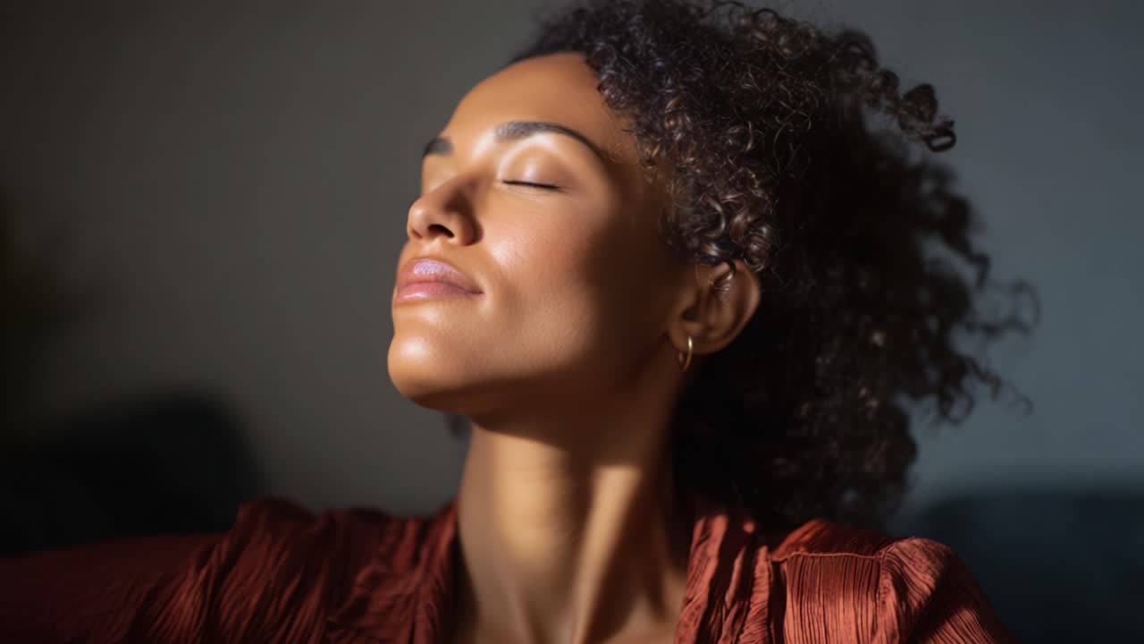 Captivating Moment of Serenity: A Woman with Beautiful Curly Hair and a Peaceful Expression in Soft Light, Evoking Calmness and Inner Peace