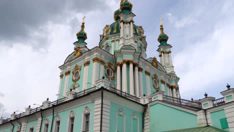 ukraine, kyiv's famous st.andrew church's, footage starts from the flea market set up on the hill that goes to the church and shows the church from bottom upon a summer day with cloudy skies.