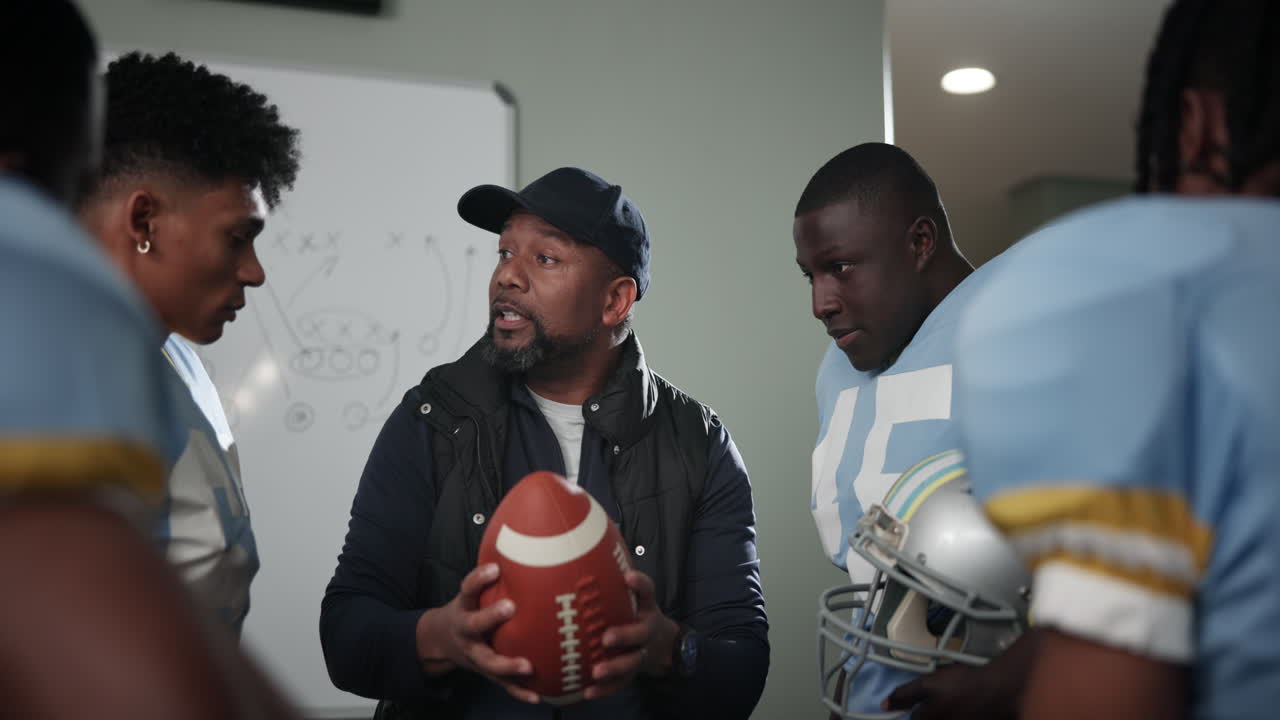 Football coach discussing game strategy with team