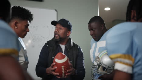 football coach discussing game strategy with team