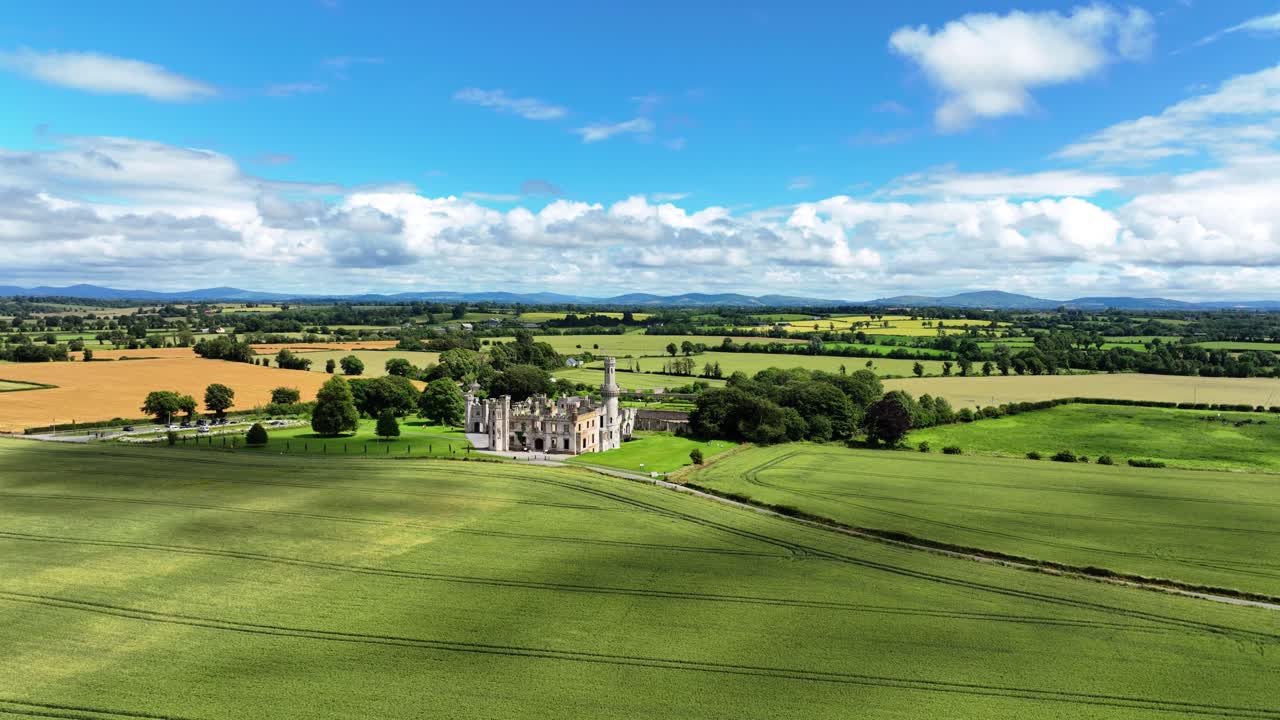 Drone panning left landscape view of Haunted Ducketts Grove Castle Carlow Ireland in Summer