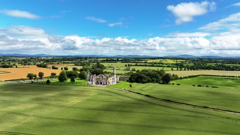 drone panning left landscape view of haunted ducketts grove castle carlow ireland in summer