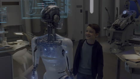 a boy interacting with a transparent robot in a lab