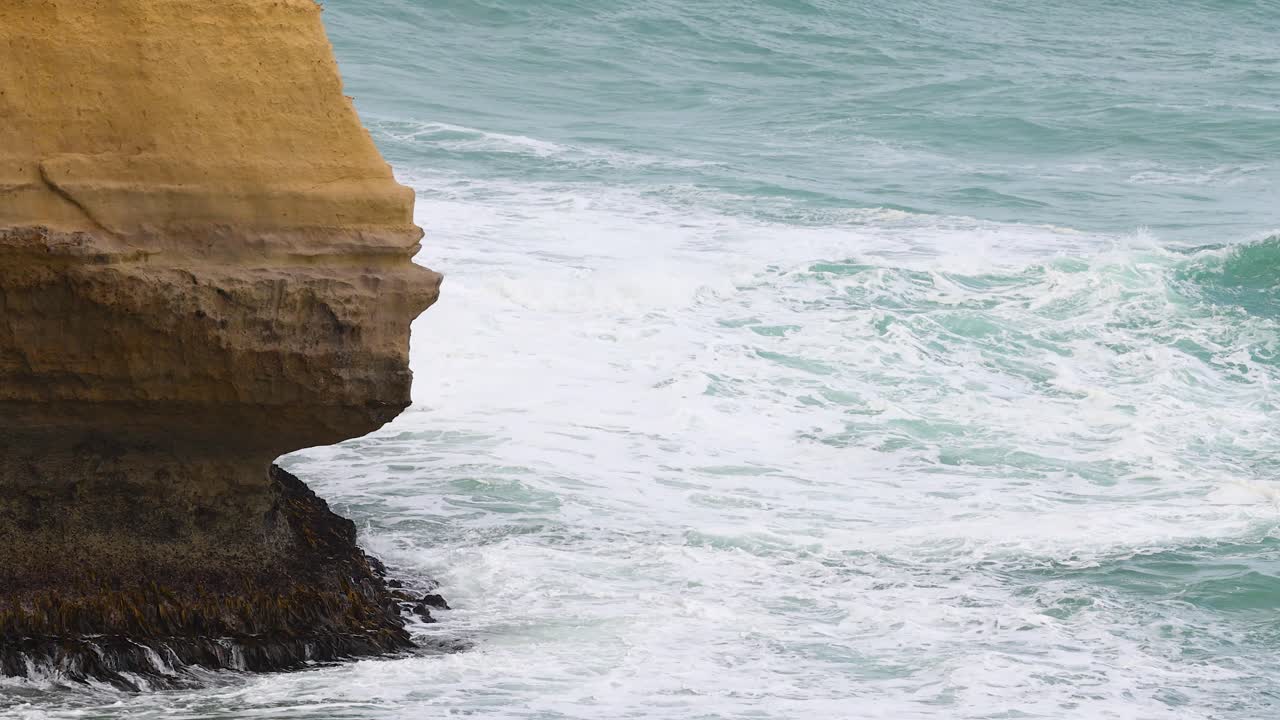 Coastal Waves Crashing Against Cliff