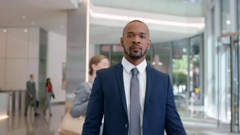 shot of a young businessman standing in a lobby at work