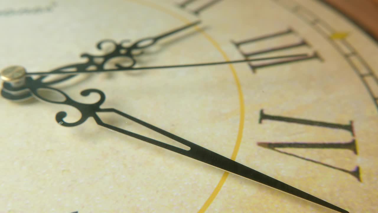 Clock face with Latin digits and hands pointing twenty-three minutes past two