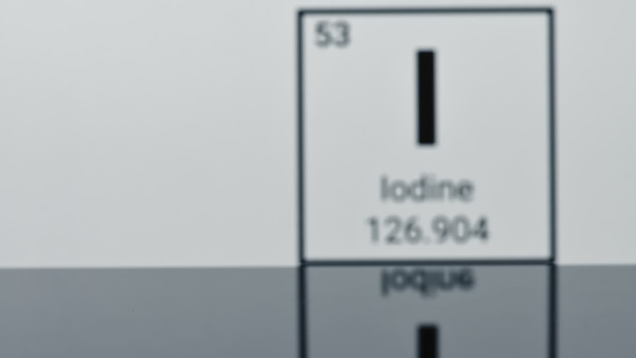 Man puts a jar with anti-radiation iodine pills on the table, chemical element of Iodine on the background