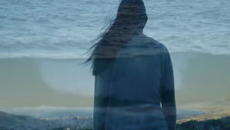 woman raising her hands over the sea