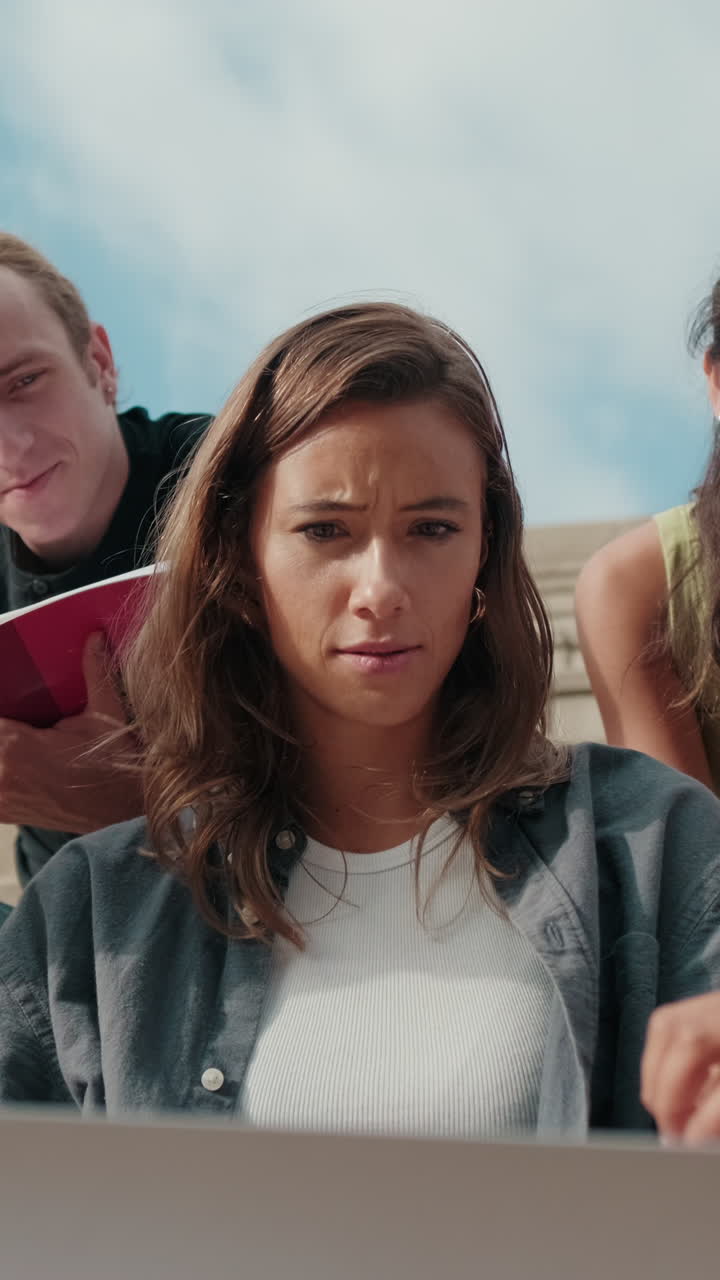 Friendly group of multiracial high-school students using computer technology