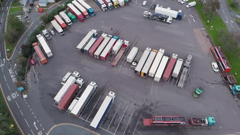 rising drone aerial view of lorries and trucks parked at gordano motorway services, illustrating rest stop activity, bristol, uk, october 2024