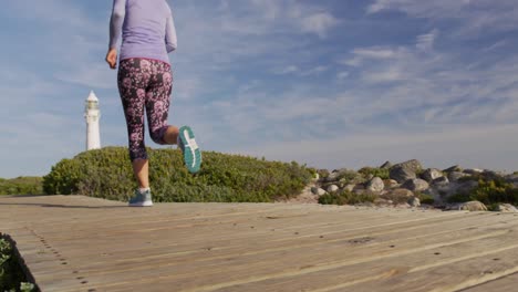 caucasian woman enjoying free time by sea on sunny day running path