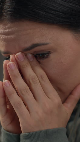 video vertical de cerca en el rostro de una mujer ansiosa sentada en el sofá trabajando desde casa usando una computadora portátil preocupada por la crisis del costo de la vida 4