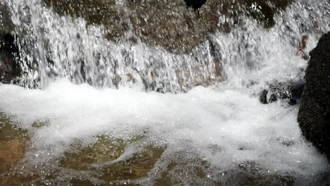 impressive slow motion shot of water cascading in mountain stream shot at 180 frames per second