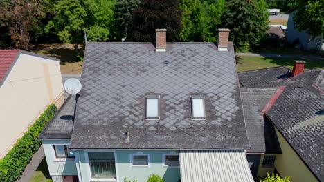 fly away at old roof made of eternit gray tile in a residential building