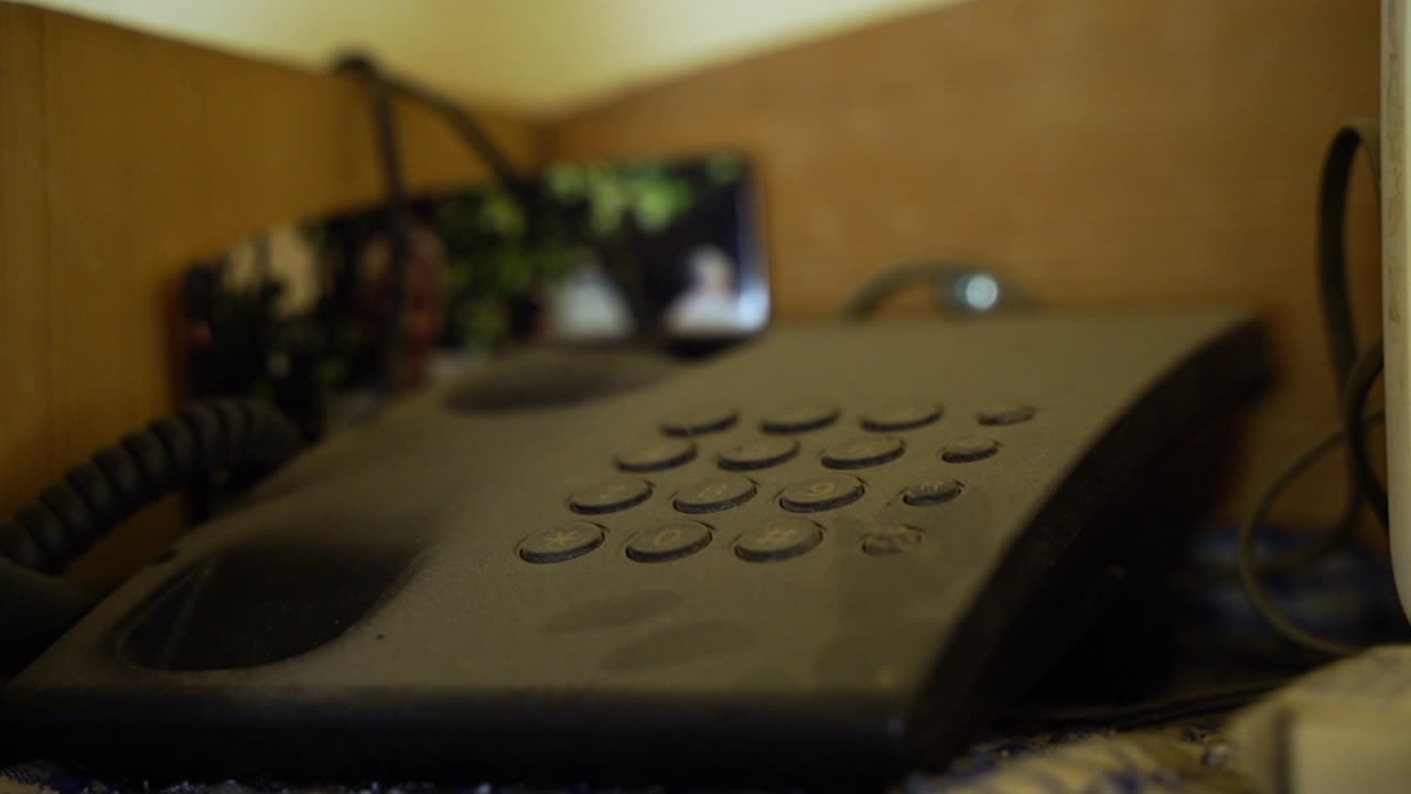 A hand answers an old phone