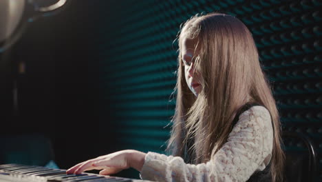 child captivates with synthesizer tunes. little girl graces music center weaving delightful melody through digital instrument. dedicated performance