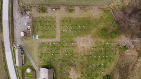 bird's eye view on old church with graves in sel, norway - aerial drone shot