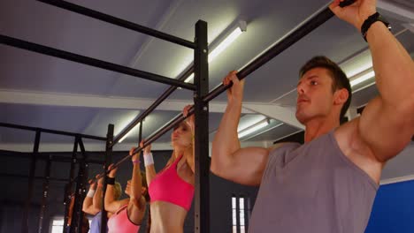 Group-of-fitness-people-performing-pull-up
