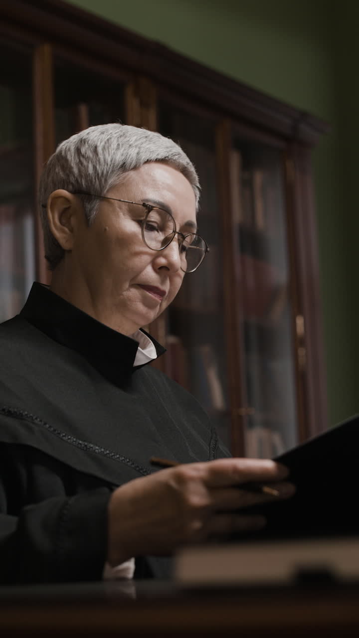 Focused Senior Lawyer Working in a Library Setting