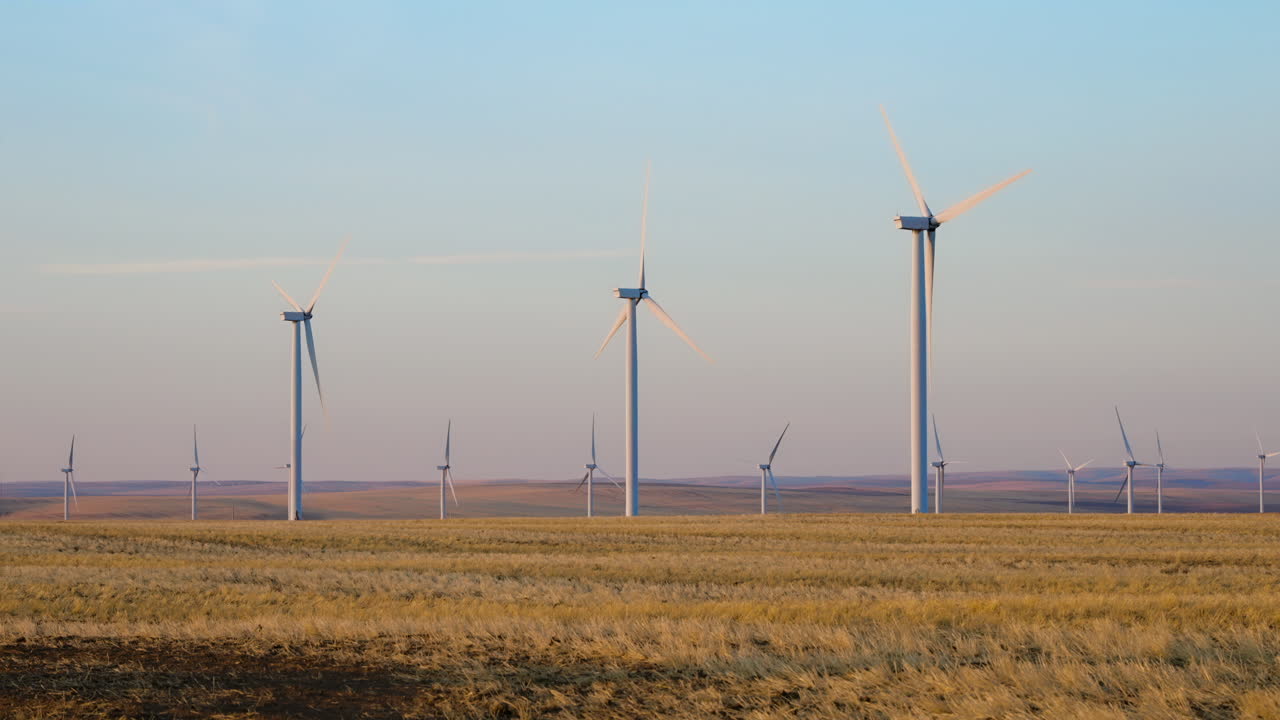 Several Wind Turbine Farm At Sunset Producing Renewable Energy In Oregon, USA. Slow Motion, Static