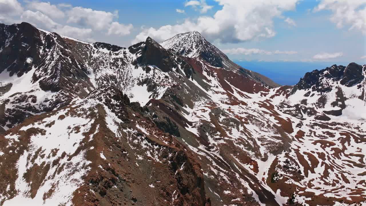 Mt Mount Lindsey Spring summer snow fields melting morning blue sky clouds Sangre De Cristo Range aerial drone Colorado high Rocky Mountains summit Sierra Blanca Massif Fort Garland circle left motion