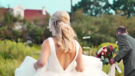 bride running through field in slow motion