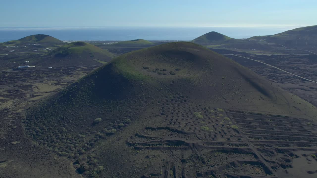 Aerial drone view of mountain sea and volcanoes in Lanzarote, Canary Islands, Spain